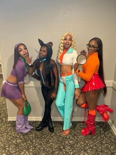 four women dressed in costumes posing for the camera