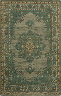 a green rug with an ornate design on the bottom and sides, in various colors