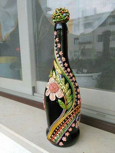 a black vase sitting on top of a window sill