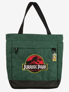 a green tote bag with an image of a dinosaur on it