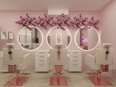 a salon with pink flowers and mirrors on the wall, all around it is decorated in white