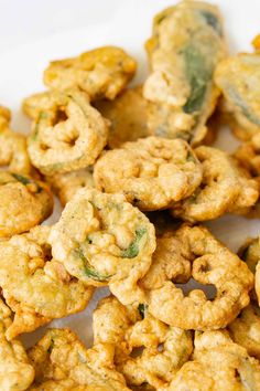 some fried food on a white plate with broccoli florets in the middle