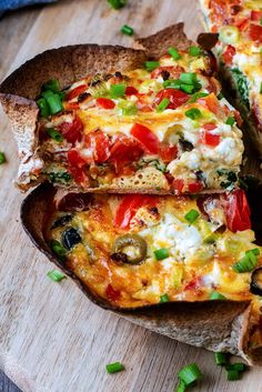 a pizza cut into slices sitting on top of a wooden cutting board