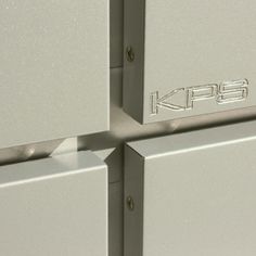 two metal boxes with the word kfcc on them are stacked up against each other