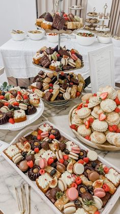 desserts and pastries are on display at a buffet table