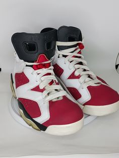 This Nike Air Jordan 6 Retro OG Mid Carmine sneaker is a must-have for any sneaker enthusiast. The shoe features a mid-top silhouette, white colorway, and the iconic Jordan 6 Retro OG Carmine design. It is made for men and is available in size 9.5. The shoe is perfect for athletic activities and is coded with the style code CT8529-106. The sneaker is of the brand Jordan and is an excellent addition to any sneaker collection. Dynamic Mid-top Jordan Shoes For Streetwear, Retro Mid-top Basketball Sneakers, Air Jordans 6 Retro, 6 Rings Jordans, Wmns Air Jordan 6 Retro 'gold Hoops', Air Jordan 6 Retro, Nike Air Jordan 6, Jordan 6 Retro, Air Jordan 6