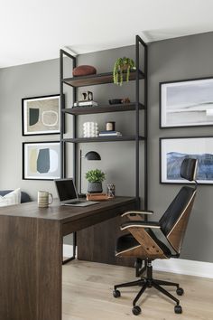 a home office with gray walls and wooden furniture