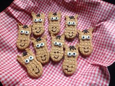 some cookies with googly eyes are on a red and white checkered cloth