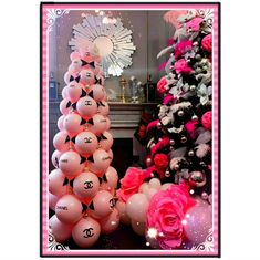 pink and white balloons with chanel logo on them in front of a christmas tree