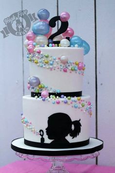 a three tiered cake with balloons on top and an instagram logo above it