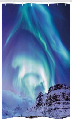 an aurora bore is seen in the sky above snow covered mountains