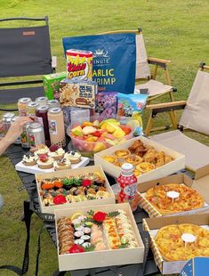 several boxes of food sitting on top of a picnic table