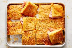 ham and cheese casserole in a baking pan with seasoning sprinkles