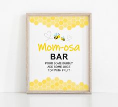 a framed sign with the words mom - osa bar on it in front of a white wall