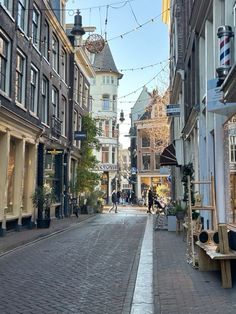 an empty city street with people walking down it