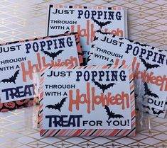 four halloween treat bags with bats on them and words that say just popin '