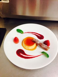 a white plate topped with food on top of a metal counter next to a microwave