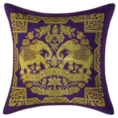 a purple and gold pillow with two elephants on it