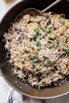 a bowl filled with oatmeal and raisins on top of a table