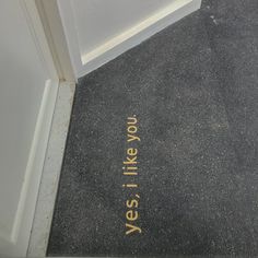 a yellow line painted on the ground in front of a door that says yes there is no