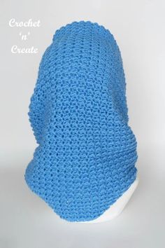 a blue crochet hat on a white mannequin head