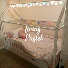 a bed with a canopy over it that says living pastel on the top and bottom