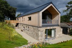 the house is made out of stone and has a metal roof on it's side