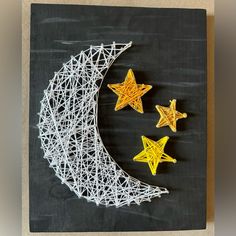 string art stars and the moon on a black board