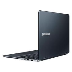 an open laptop computer sitting on top of a white surface with the word samsung written on it