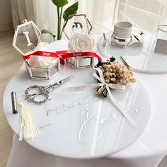 the table is set up with rings and other items for wedding guests to take home