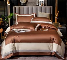 a bed with brown and white comforters in a bedroom