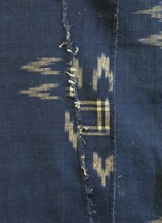 an old piece of cloth that has been torn off and is blue with gold stripes