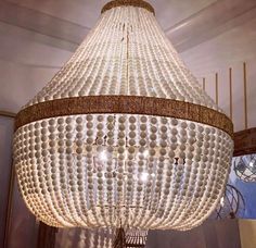 a chandelier made out of plastic balls hanging from the ceiling in a room