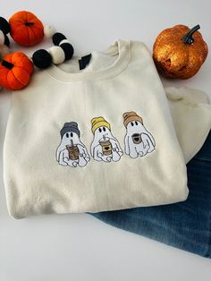 Ghost coffee sweater  Designs are embroidered  Shirt brands are Comfort color made out of 100% ringspun  Sweater brands are Gildan 18000 made out of 50% cotton 50% polyester  Wash care instructions  Turn item inside out  Machine cold wash Do not iron design  Do not bleach  Hang to dry  Any questions please message me Fall Sweater Ideas Cricut, Fall Crewneck Sweatshirt Cricut, Ghost Sweater, Halloween Embroidery Designs Sweater, Ghost Sweatshirt, Ghost Shirts, Fall Sweaters Aesthetic, Halloween Sweaters, Halloween Embroidery Shirts