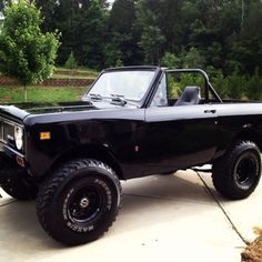 the black truck is parked on the driveway