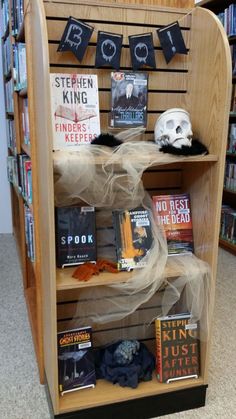 there is a book shelf with books and other items on it in the library area