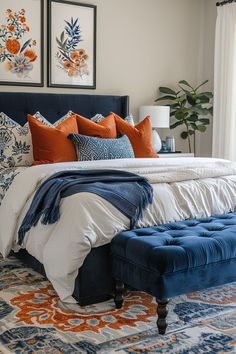 a bed with blue and orange pillows on it