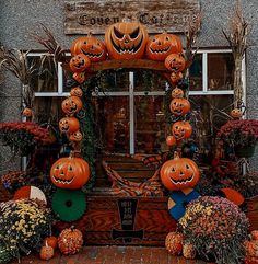 an entrance to a store decorated with pumpkins