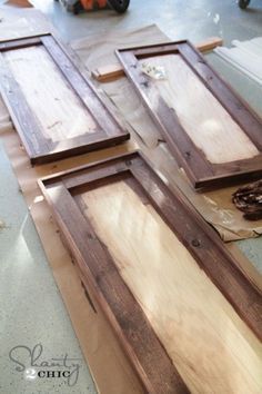 three pieces of wood sitting on top of each other in front of a door frame