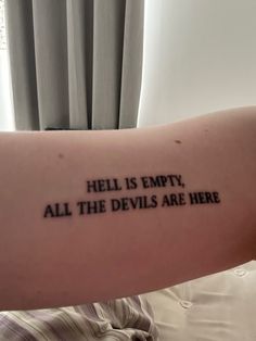 a person with a tattoo that says hell is empty, all the devils are here