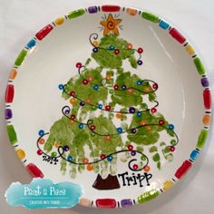 a plate with a christmas tree painted on the front and bottom, decorated with colorful beads