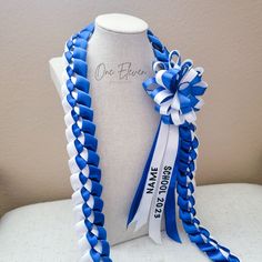 a blue and white ribbon on a mannequin