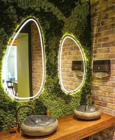 there are two sinks in the bathroom with mirrors on the wall behind them, and another sink below it