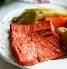 a white plate topped with meat and veggies