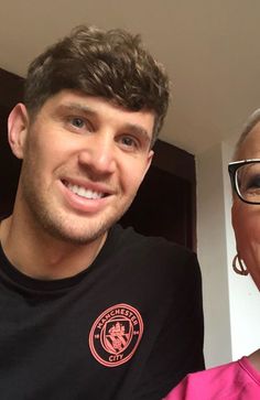 an older man and younger woman smile for the camera while taking a selfie together