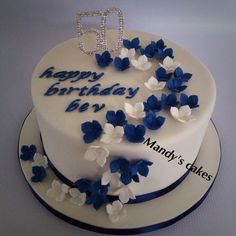 a birthday cake with blue and white flowers on the top is decorated with an i d