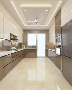 a modern kitchen with stainless steel appliances and marble counter tops, along with beige cabinets