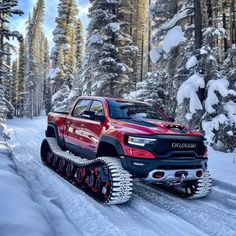 a red truck driving down a snow covered road