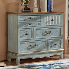 a blue dresser sitting on top of a wooden floor