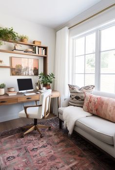 a living room filled with furniture and a computer on top of a wooden desk next to a window